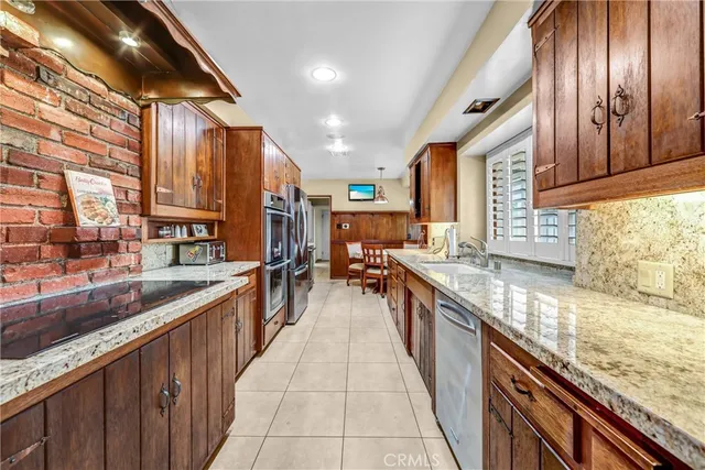 a large kitchen with stainless steel appliances granite countertop lots of counter top space