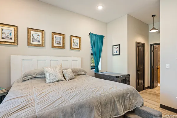 a bedroom with a large bed and a refrigerator