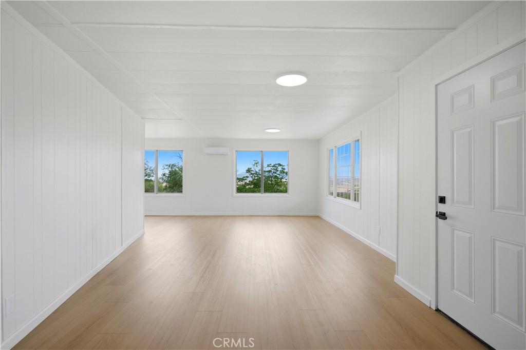 59995 Granite Gulley Road Anza, CA 92539 - Photo 11 of 33 an empty room with wooden floor and windows