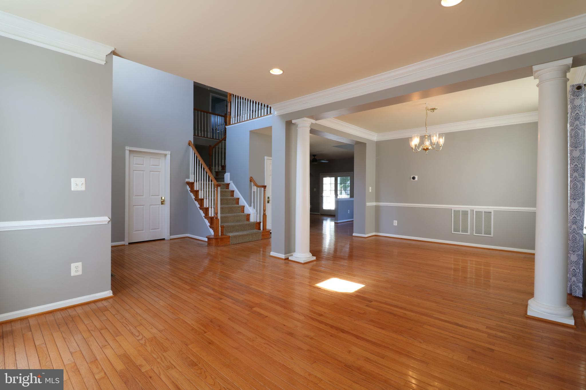 25497 Carrington Drive Chantilly, VA 20152 - Photo 4 of 41 a view of an empty room with wooden floor and a window
