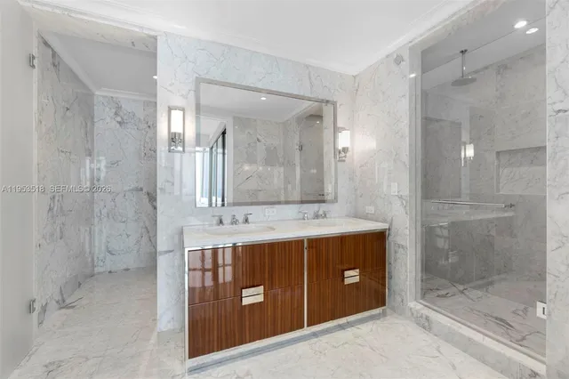 a bathroom with a double vanity sink mirror and shower