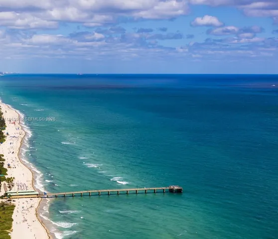 a view of a field with an ocean