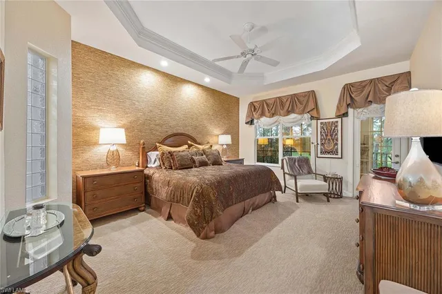 a spacious bedroom with a bed and a chandelier
