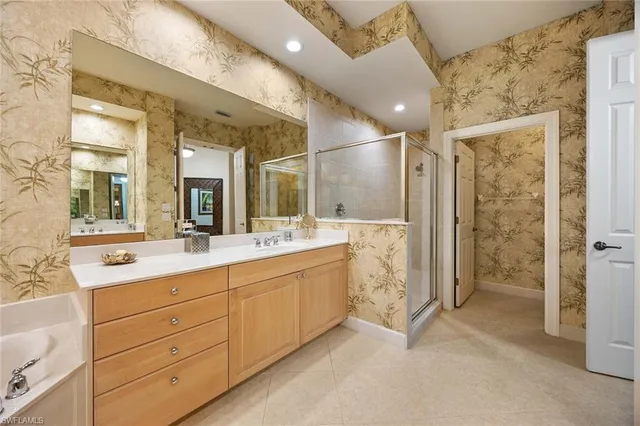a bathroom with a double vanity sink mirror and shower