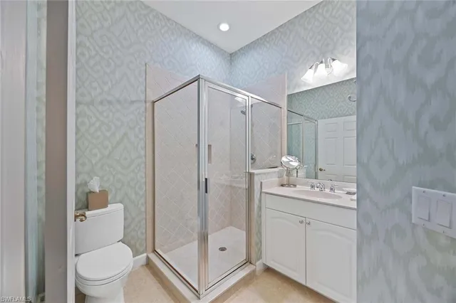 a bathroom with a double vanity sink toilet and shower