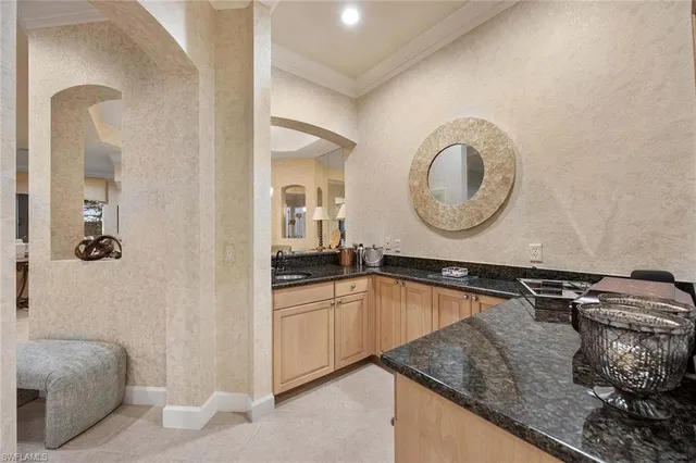 a kitchen with a sink and a mirror