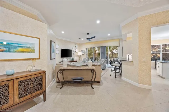 a living room with furniture a flat screen tv and a table