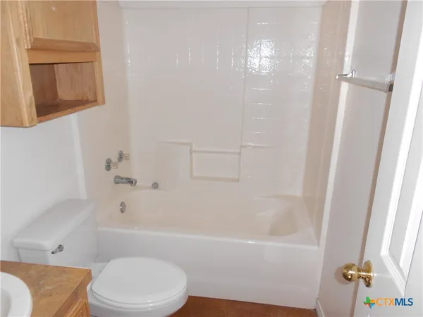 a bathroom with a bathtub toilet and sink