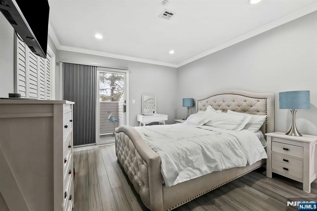 142 Main Avenue, Unit 4A Passaic, NJ 07055 - Photo 18 of 26 a bedroom with a bed and a night stand