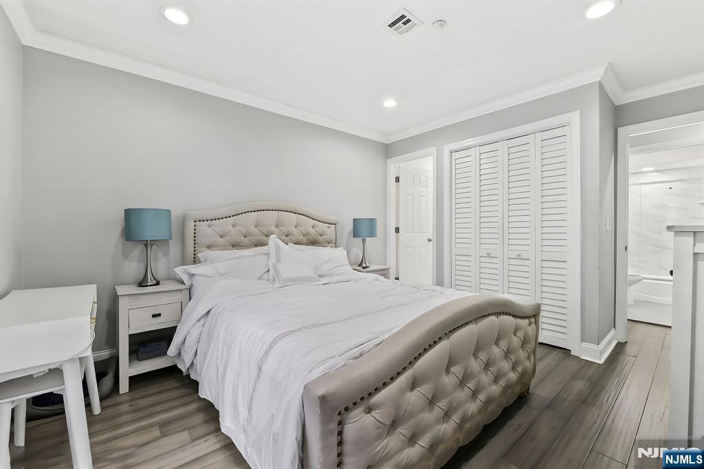 142 Main Avenue, Unit 4A Passaic, NJ 07055 - Photo 22 of 26 a bedroom with a bed and a table