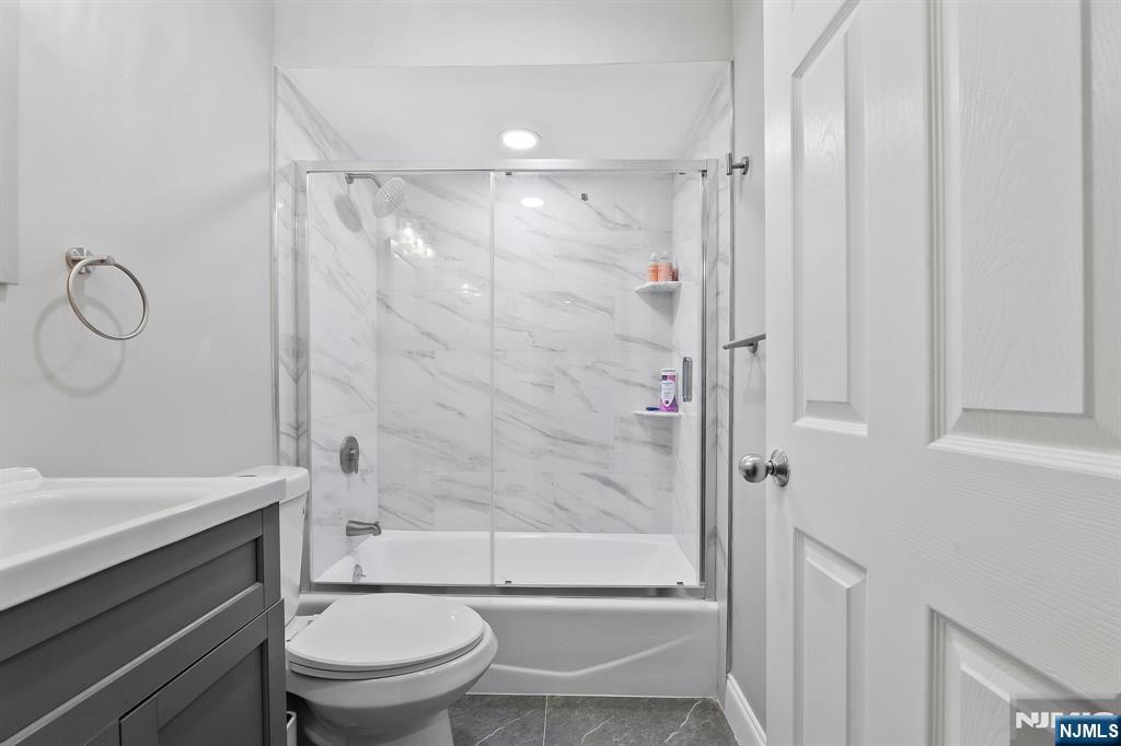 142 Main Avenue, Unit 4A Passaic, NJ 07055 - Photo 24 of 26 a bathroom with a shower a toilet and a sink