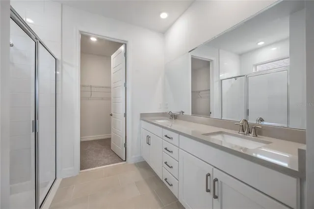 a bathroom with a shower and a glass door