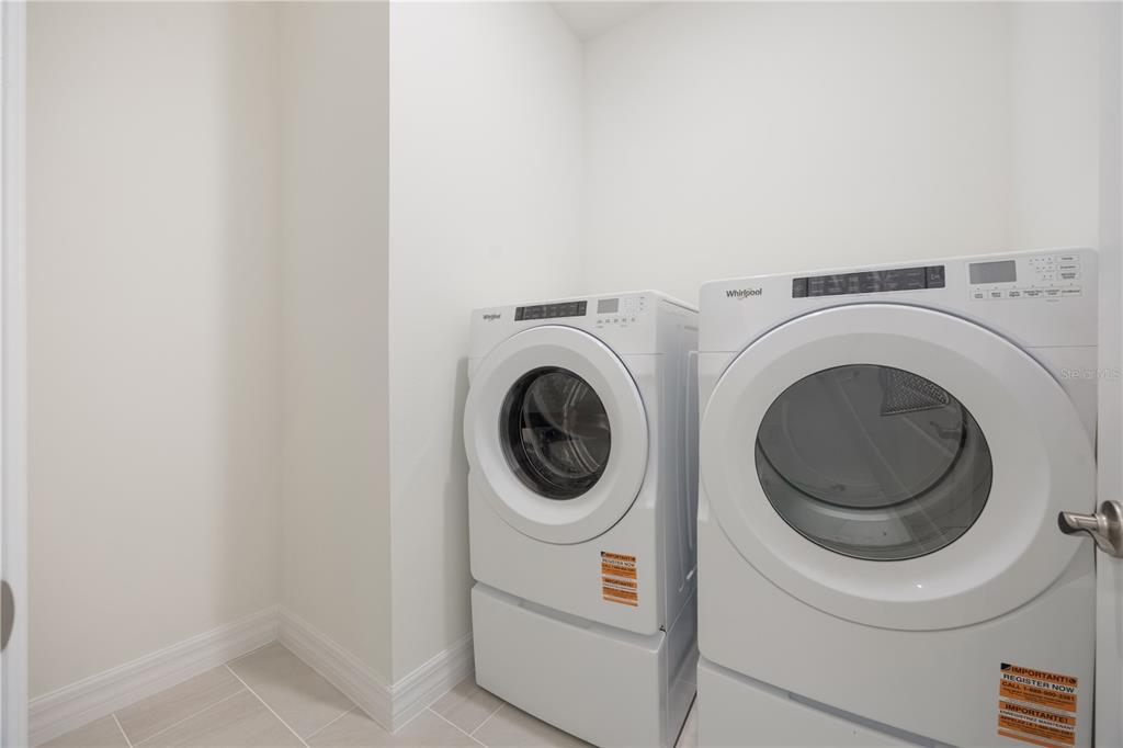 3944 Kennebunk Loop Mount Dora, FL 32757 - Photo 29 of 32 a utility room with dryer and washer