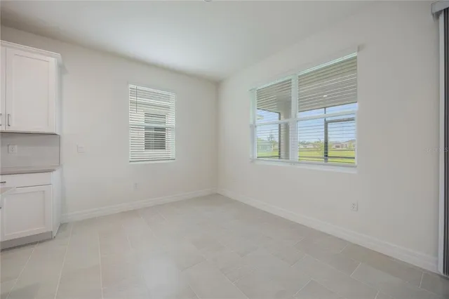 a view of a kitchen with a sink and white cabinets