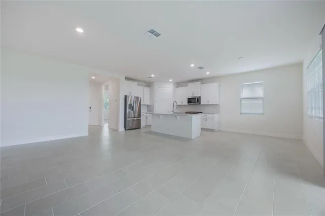 a view of kitchen with refrigerator sink and wooden floor
