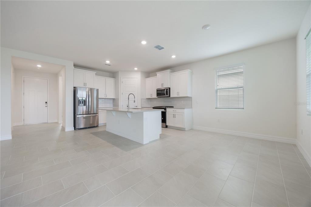 3944 Kennebunk Loop Mount Dora, FL 32757 - Photo 9 of 32 a view of kitchen with refrigerator sink and wooden floor