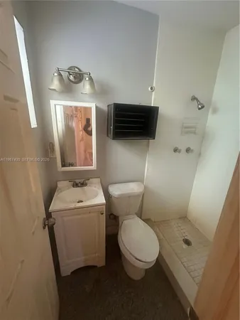 a white toilet sitting next to a bathroom sink