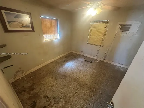 a view of a room with wooden floor and window