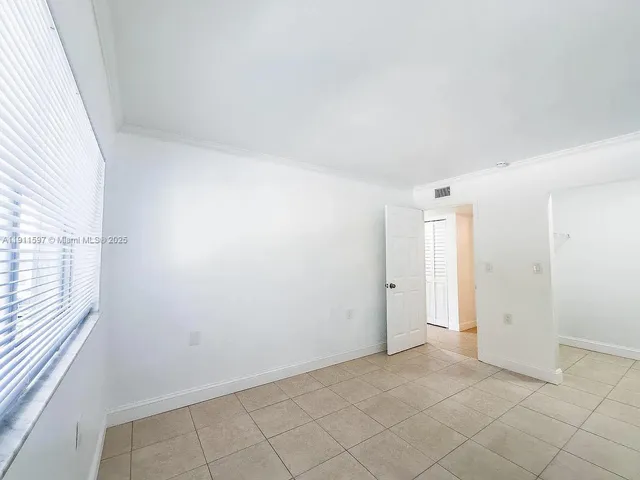 a view of a livingroom with wooden floor and cabinet