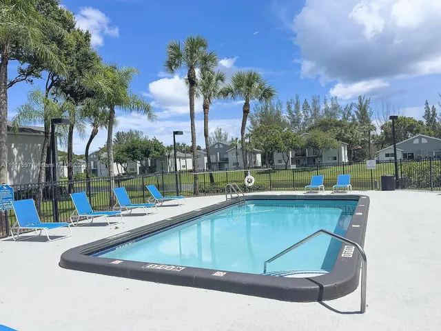 a view of a fence and trees