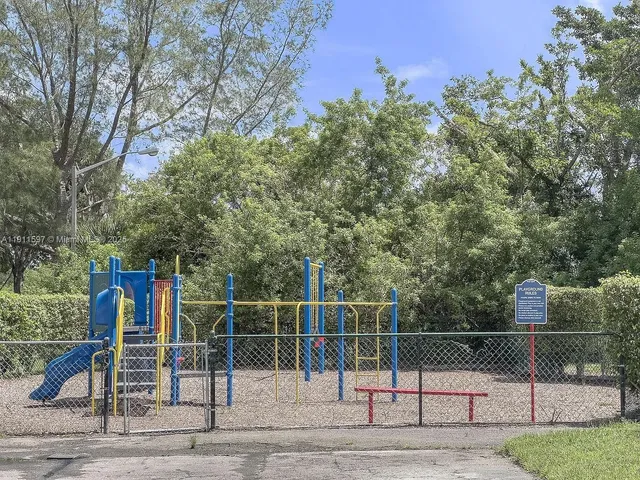 a view of a house with a yard and pathway
