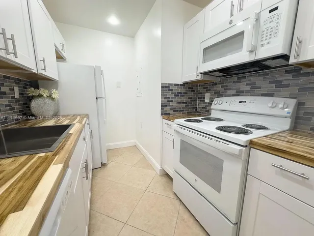 a kitchen with a stove and a microwave