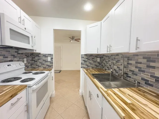 a kitchen with stainless steel appliances granite countertop a sink and cabinets