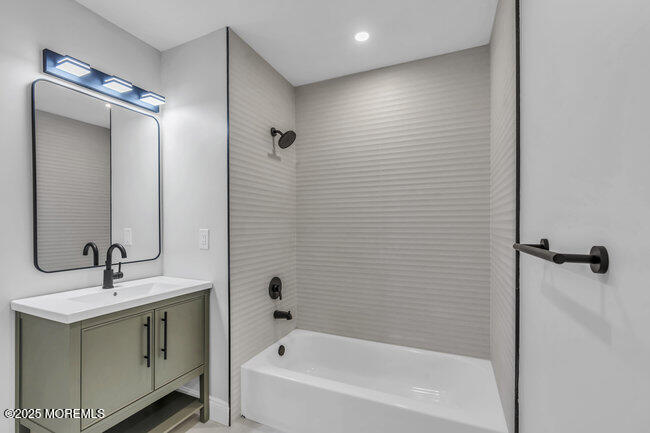 11 Sedgwick Square Jackson, NJ 08527 - Photo 16 of 19 a bathroom with a bathtub sink vanity and mirror