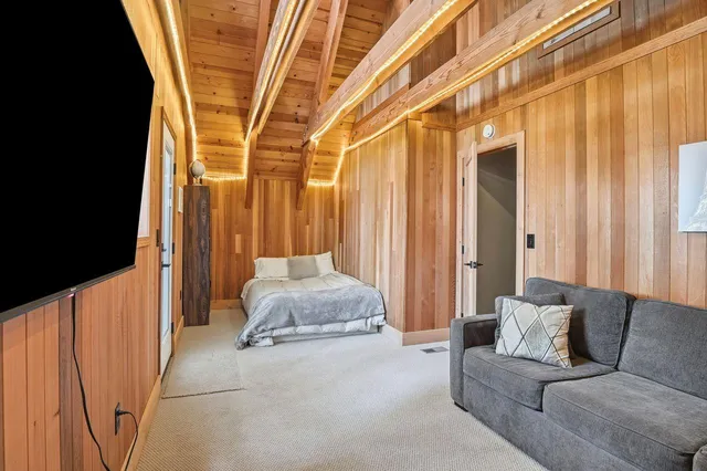 a bedroom with a bed and a curtain