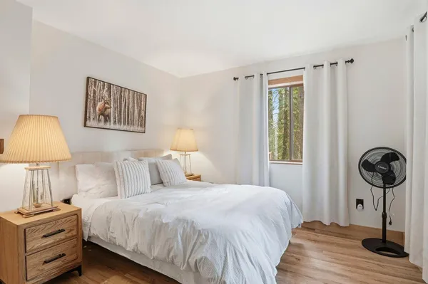 a bedroom with a bed and a lamp