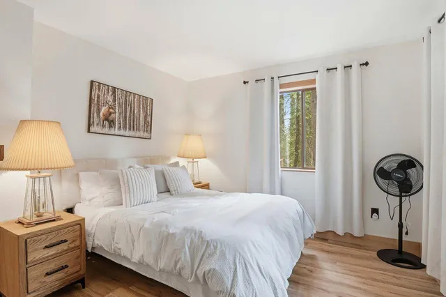 a bedroom with a bed and a lamp