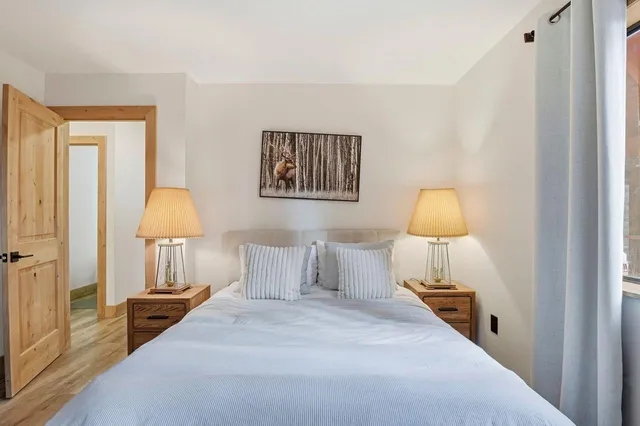 a bedroom with a bed a couch and a window