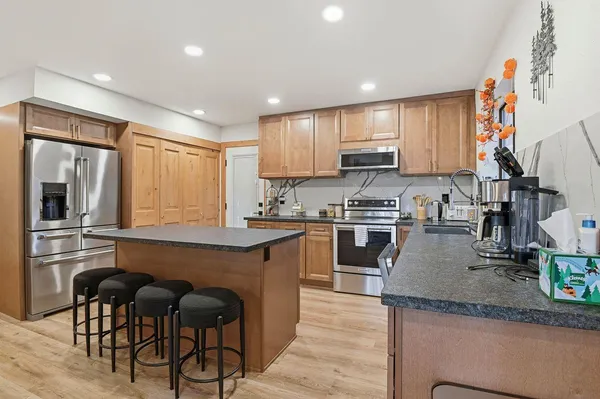 a kitchen with granite countertop sink cabinets and stainless steel appliances
