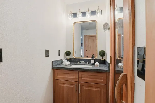 a bathroom with a double vanity sink and a mirror