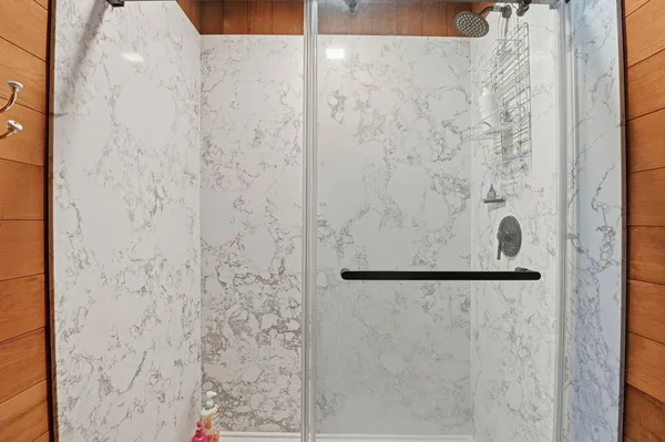 a bathroom with a shower toilet and sink
