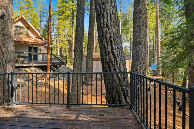 a view of balcony with wooden floor and fence