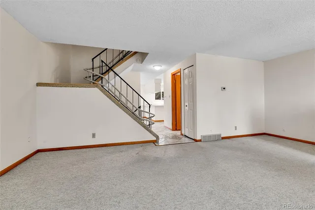 a view of an empty room with stairs