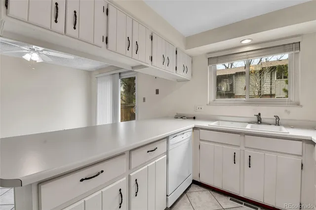 a kitchen with stainless steel appliances white cabinets and a refrigerator