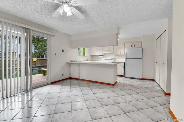 a view of an empty room with a fan
