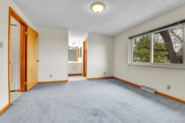 an empty room with closet area