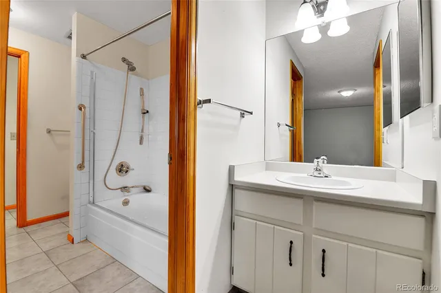 a view of an empty room with closet and workspace