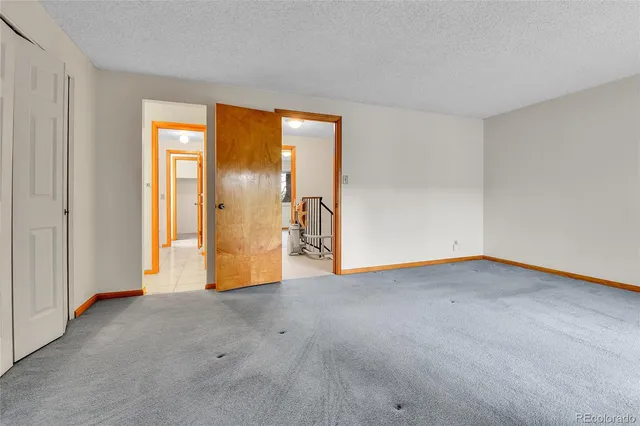 an empty room with windows and entrance