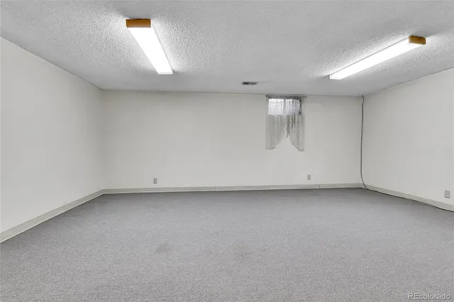 a view of an empty room with stairs and stairs