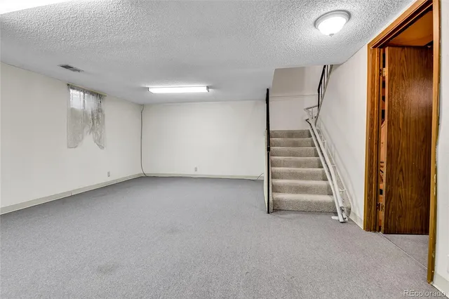 a view of a livingroom with stairs