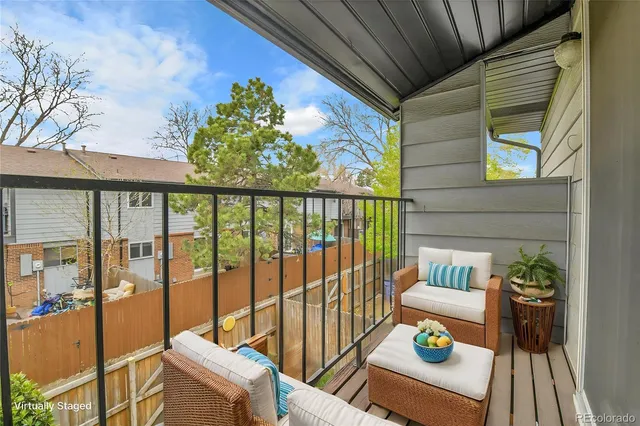 a view of balcony with furniture and garden
