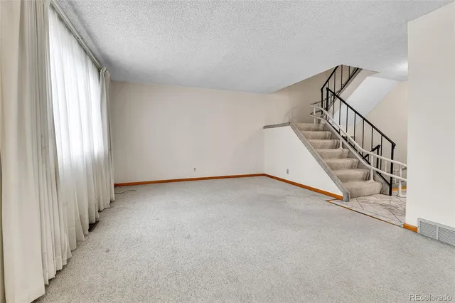 a view of an empty room with stairs