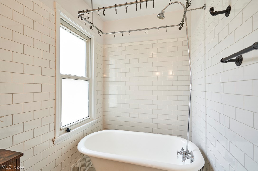 780 Bates Road Rocky River, OH 44116 - Photo 15 of 35 Clawfoot tub with polished chrome fixtures, surrounded by white subway tile walls