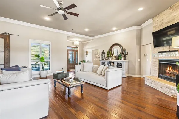 a living room with fireplace furniture and a flat screen tv