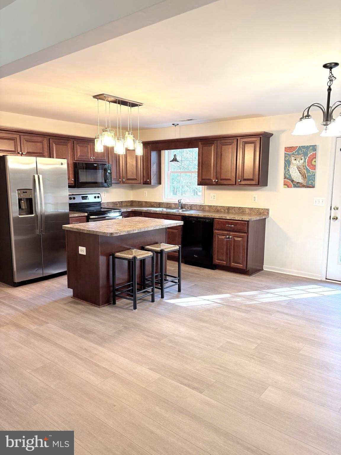 18162 White Tail Way St. Inigoes, MD 20684 - Photo 11 of 29 a kitchen with stainless steel appliances granite countertop a stove and a refrigerator