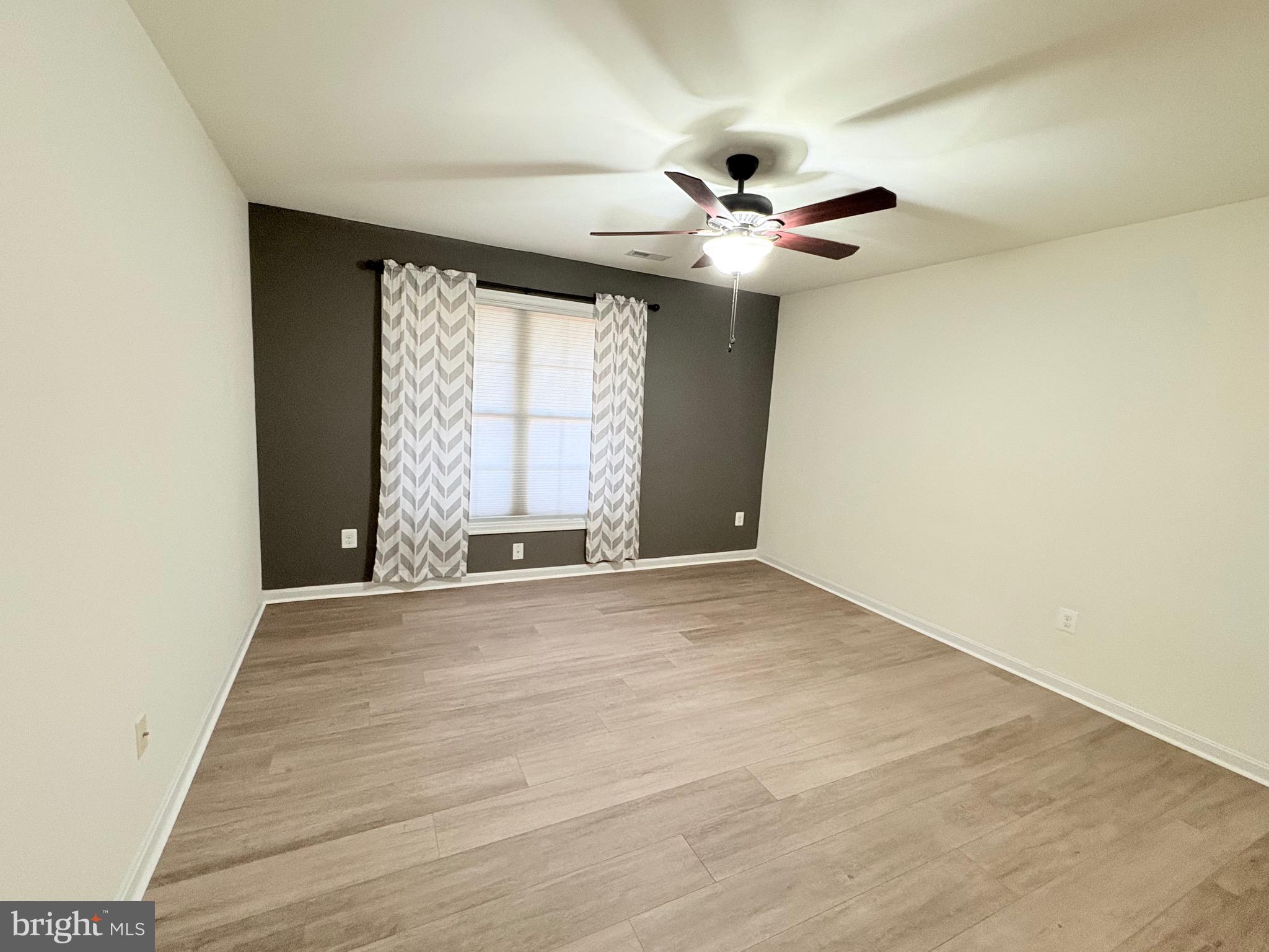 18162 White Tail Way St. Inigoes, MD 20684 - Photo 14 of 29 an empty room with windows and fan